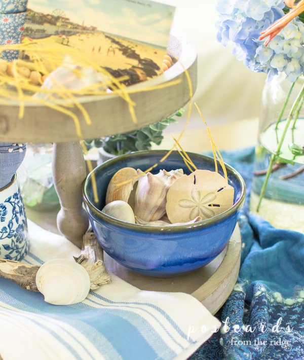 蓝色的陶瓷碗与贝壳上的木质分层托盘