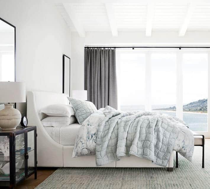 蓝色和白色海岸祖母风格的卧室，柔软的亚麻床上用品和软垫床